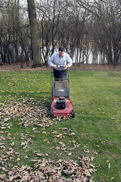 A person mowing leaves